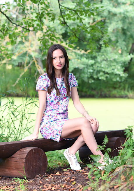 Shapely dark-haired young Dama in lingerie revealing her ass and spreading her legs outside